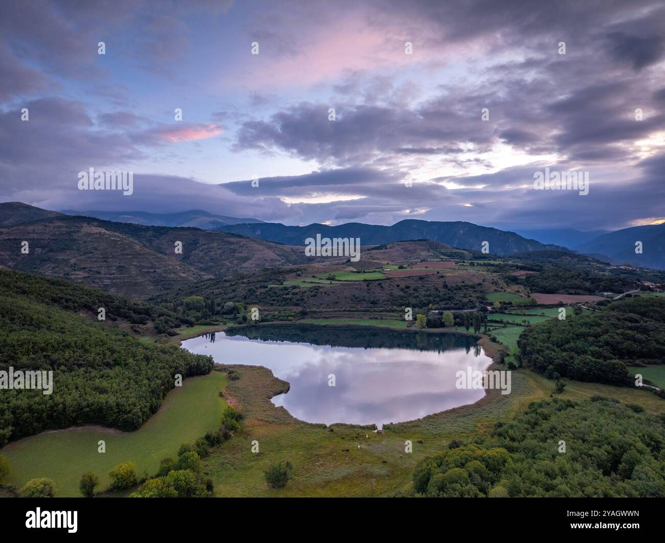 Aus der Vogelperspektive auf den See Estany de Montcortès, bei einem bewölkten Sonnenaufgang in Baix Pallars (Pallars Sobirà, Lleida, Katalonien, Spanien, Pyrenäen) Stockfoto