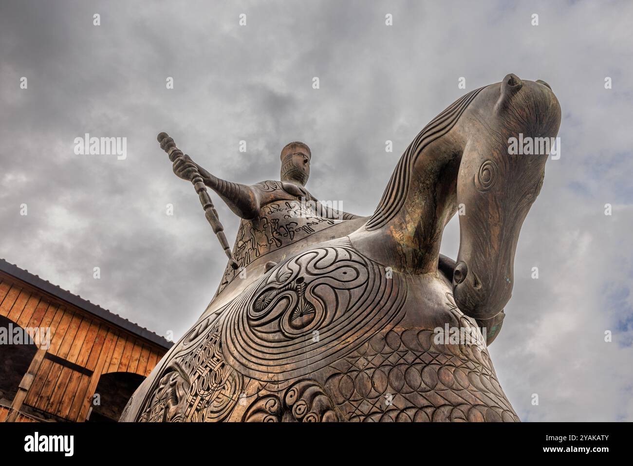 Große Bronzestatue des weiblichen Königs tamar dem Großen auf dem seti-Platz in mestia von unten aus mit Blick auf einen bewölkten Himmel Stockfoto