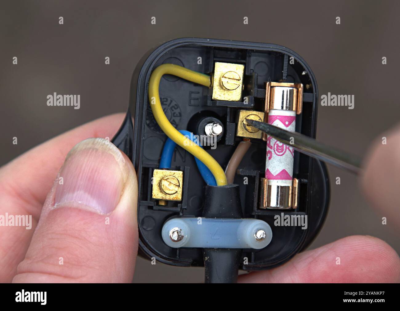 Eine Person, die einen schwarzen britischen 3-poligen elektrischen Stecker verdrahtet Stockfoto