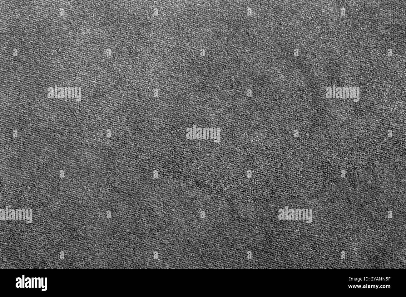 Nahaufnahme einer glatten grauen Stoffstruktur mit einheitlichem, gewebtem Aussehen. Stockfoto