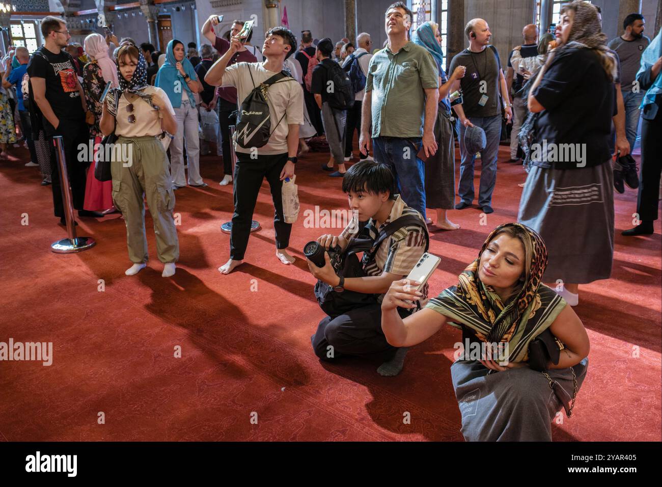 Touristen fotografieren in der Blauen Moschee, Istanbul, Türkei Stockfoto
