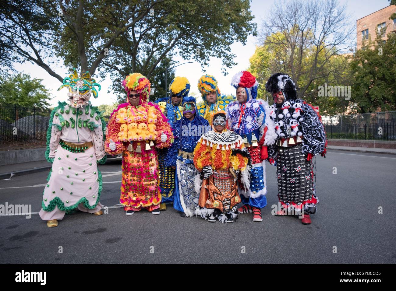Ein Gruppenfoto von 6 Männern und einem 7-Jährigen, alle in aufwendigen Kostümen. Vor der Dominikanischen Tagesparade. In Jackson Heights, Queens, NY, 2024. Stockfoto