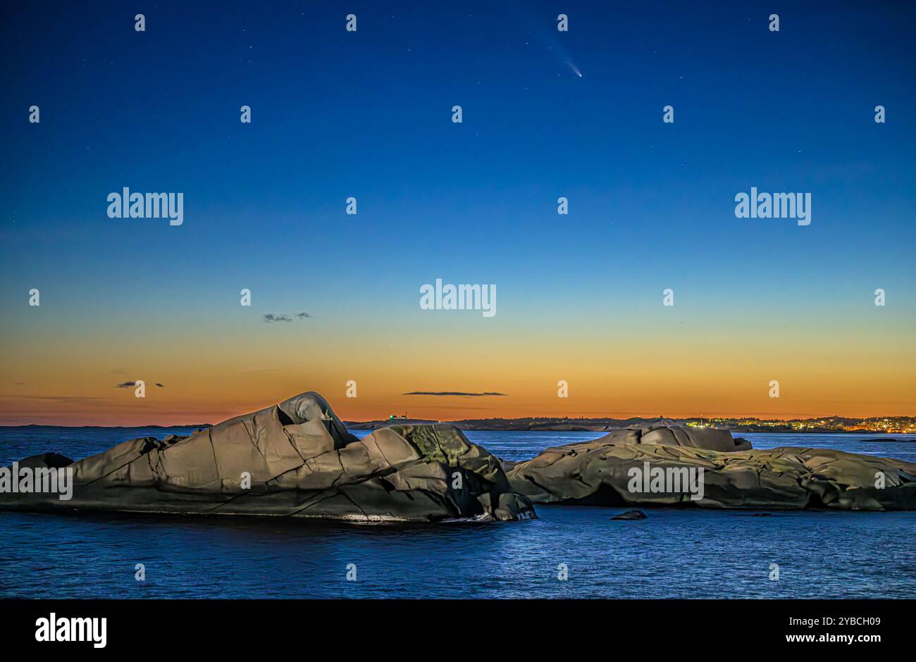 Ein Komet kommt über die Küste im Sonnenuntergang. Farbiger Himmel Stockfoto