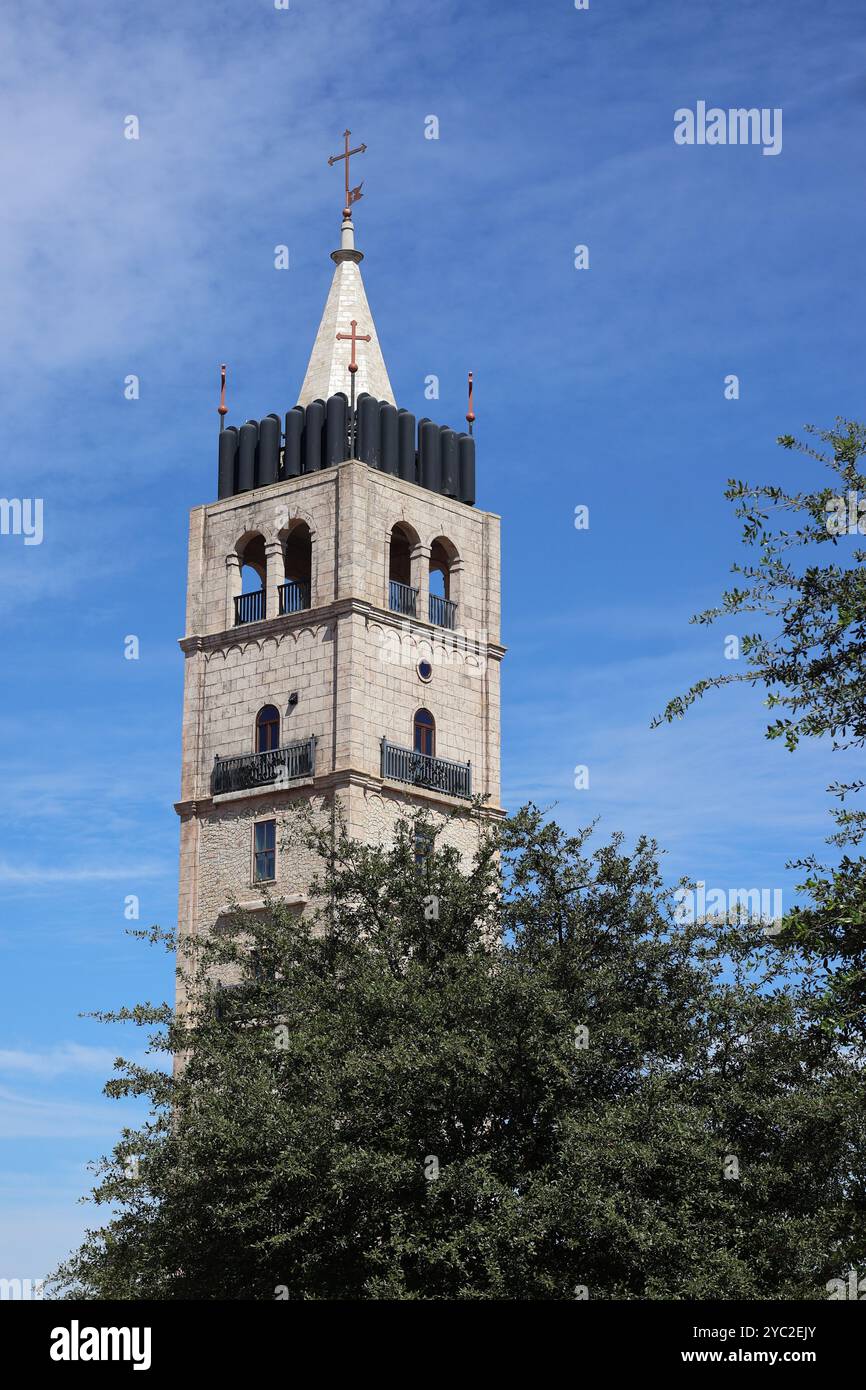 Hoher Steinturm mit Türmen und Kreuz Stockfoto