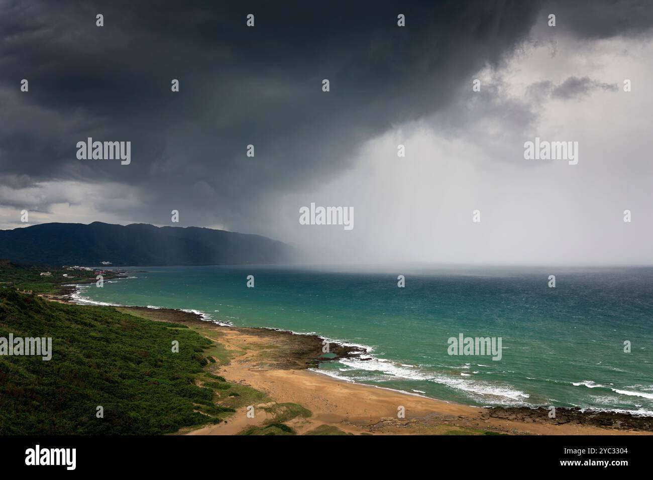 Stürmische Wolken und Regen nahe dem Strand Stockfoto