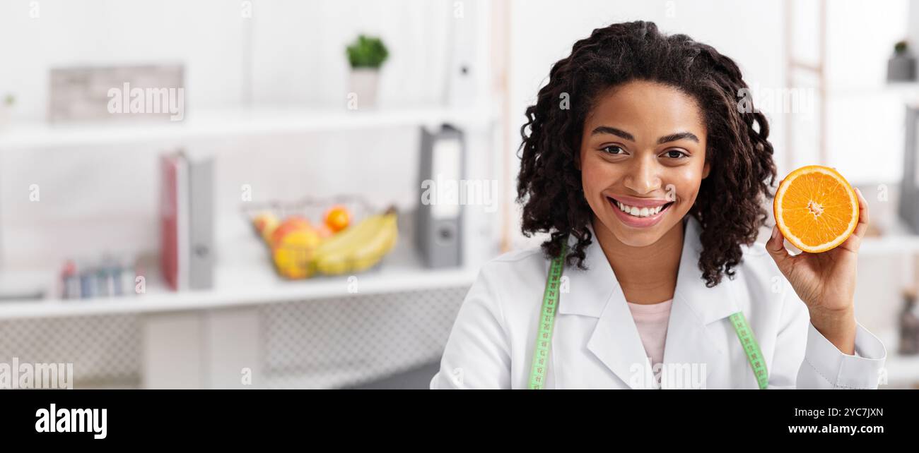 Nahaufnahme des weiblichen Arztes, der die orangefarbene Hälfte hält Stockfoto