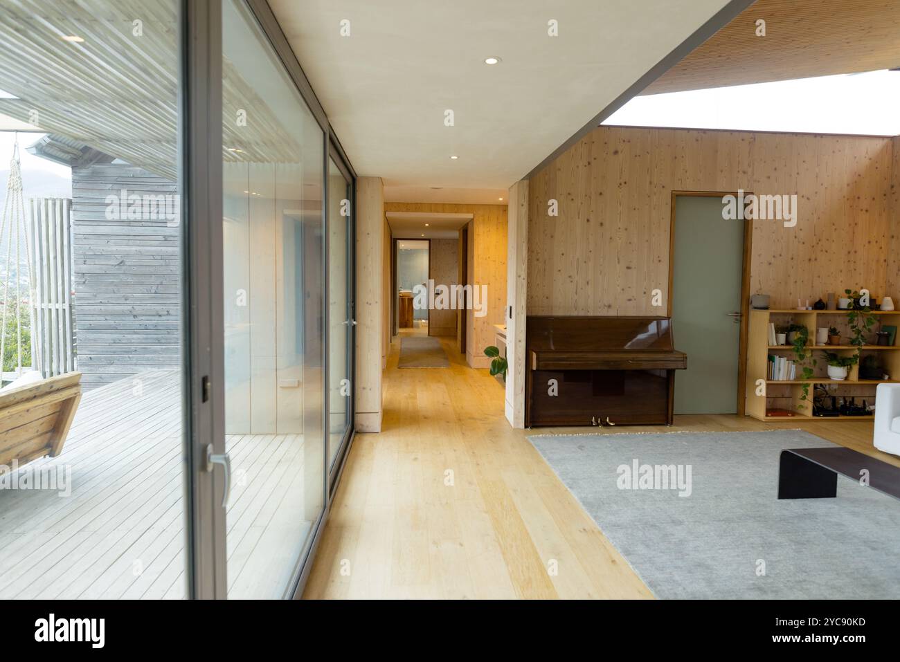 Moderne Holzeinrichtung mit Klavier und Pflanzen, minimalistisches Wohndesign Stockfoto