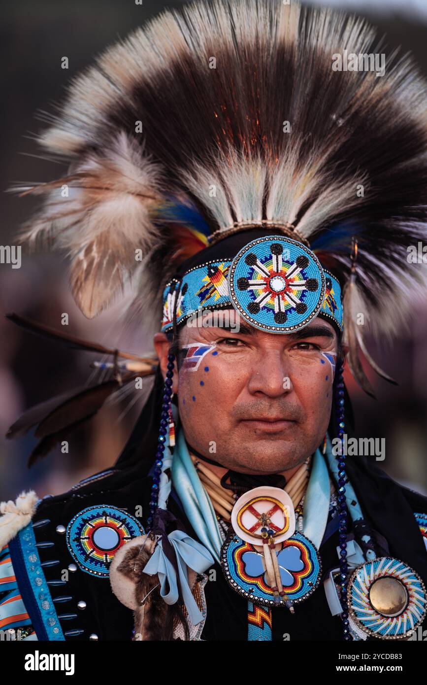 Porträt eines Indianers mit traditionellen Insignien, verziert mit lebendigen Perlen und einem gefiederten Kopfschmuck, der kulturellen Stolz zum Ausdruck bringt Stockfoto