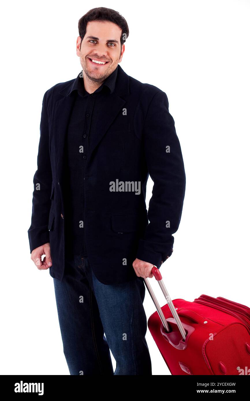Junger Mann, der mit einer Reisetasche auf einem isolierten Hintergrund steht Stockfoto