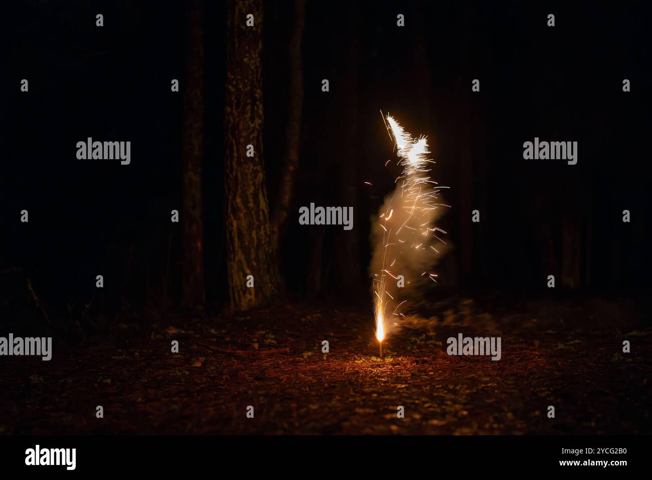 Explodierendes Feuerwerk am Boden in der Nacht. Feuerwerk mit dunklem Nachthintergrund. Glitzernder Pyro-Brunnen Feuerwerk Vulkan am Silvesterabend Stockfoto