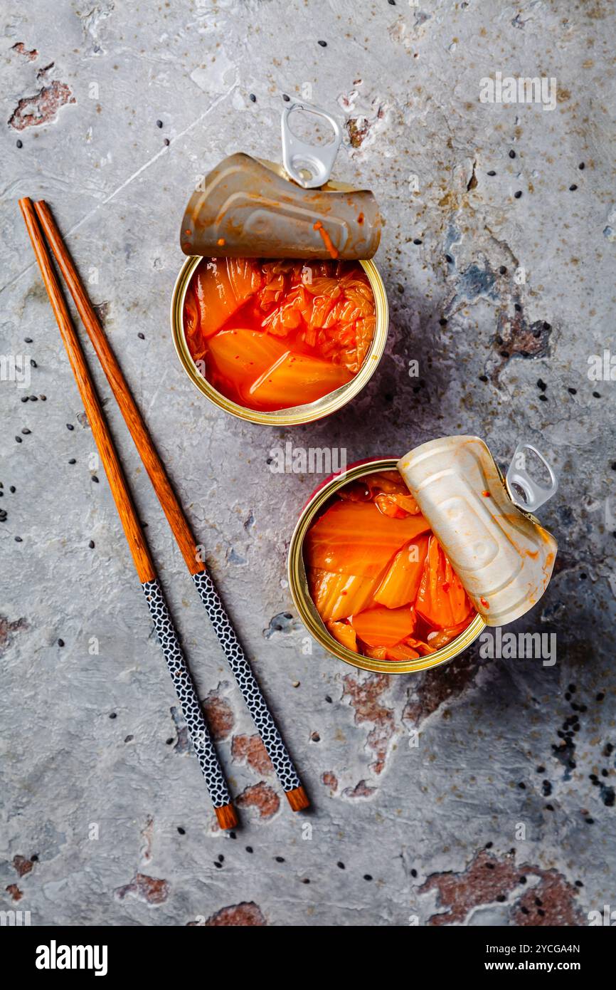 Zwei Dosen mit Kimchee auf grauem Küchentisch Stockfoto
