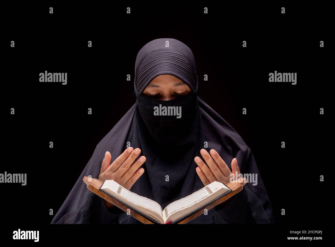 Portrait asiatische muslimische Frau, die den Qur´an steht und liest und schätzt und glaubt dem Heiligen Al Qur´an mit schriftlicher arabischer Kalligraphie Bedeutung von Al Q Stockfoto