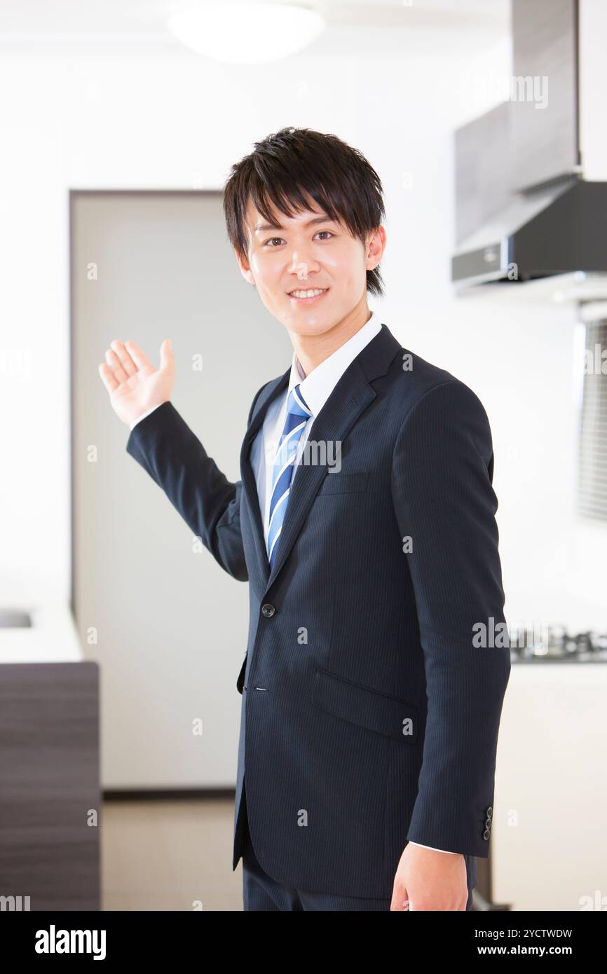 Männlicher Geschäftsmann, der Immobilien zeigt Stockfoto