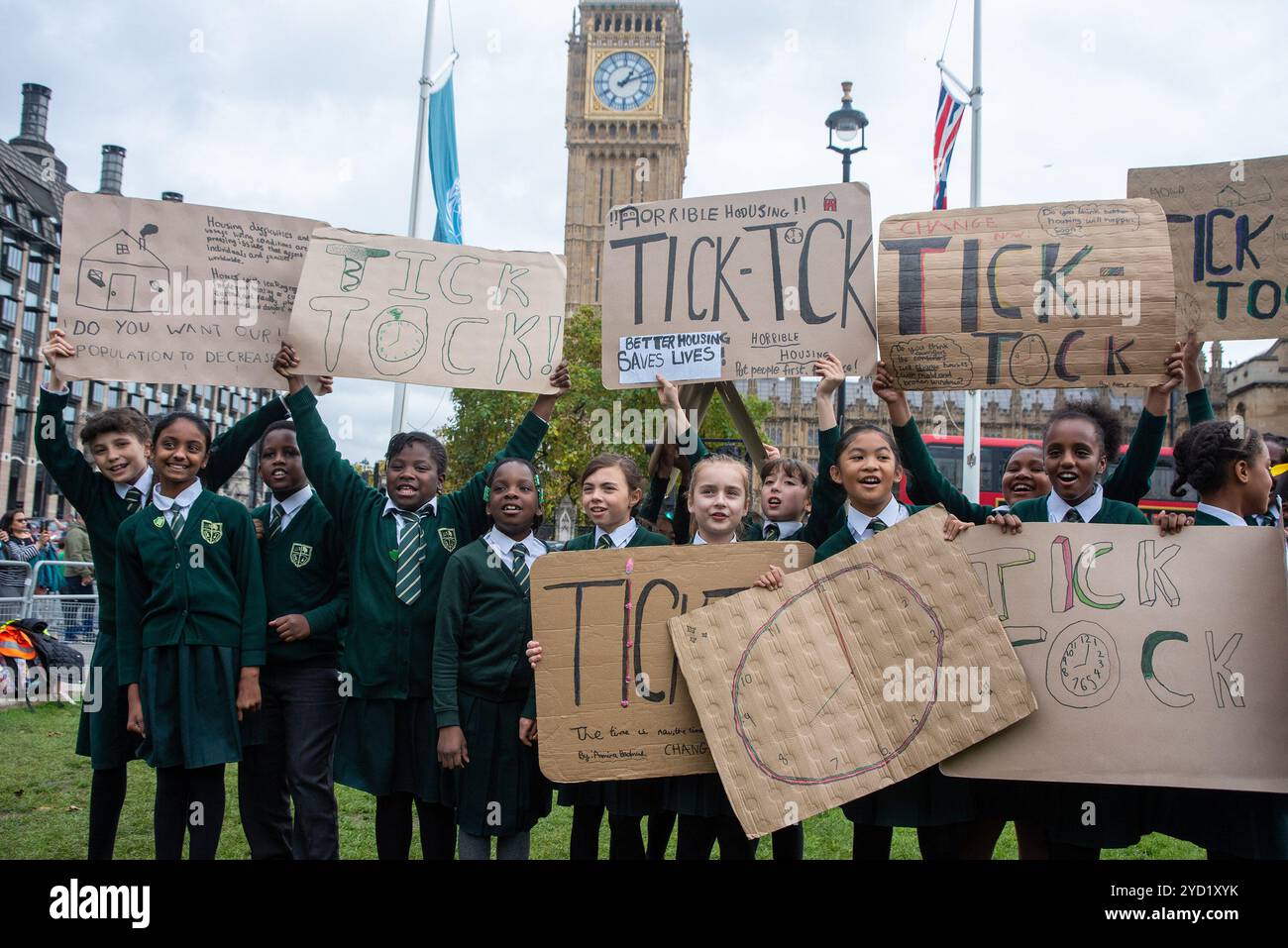 London, Großbritannien. Oktober 2024. Kinder halten Plakate vor dem Big Ben während der Proteste auf dem Parlamentsplatz. Citizens UK ist eine Basisallianz lokaler Gemeinschaften, die in England und Wales zusammenarbeiten. Die Organisation startete ihre Kampagne für Wohnraum und Obdachlosigkeit, um sicherzustellen, dass jeder Zugang zu Wohnraum und Sozialhilfe hat, um die Menschen zu schützen und vor Kälte und Hunger zu schützen. Die Kinder kamen aus Bristol, Birmingham und London. (Foto: Krisztian Elek/SOPA Images/SIPA USA) Credit: SIPA USA/Alamy Live News Stockfoto