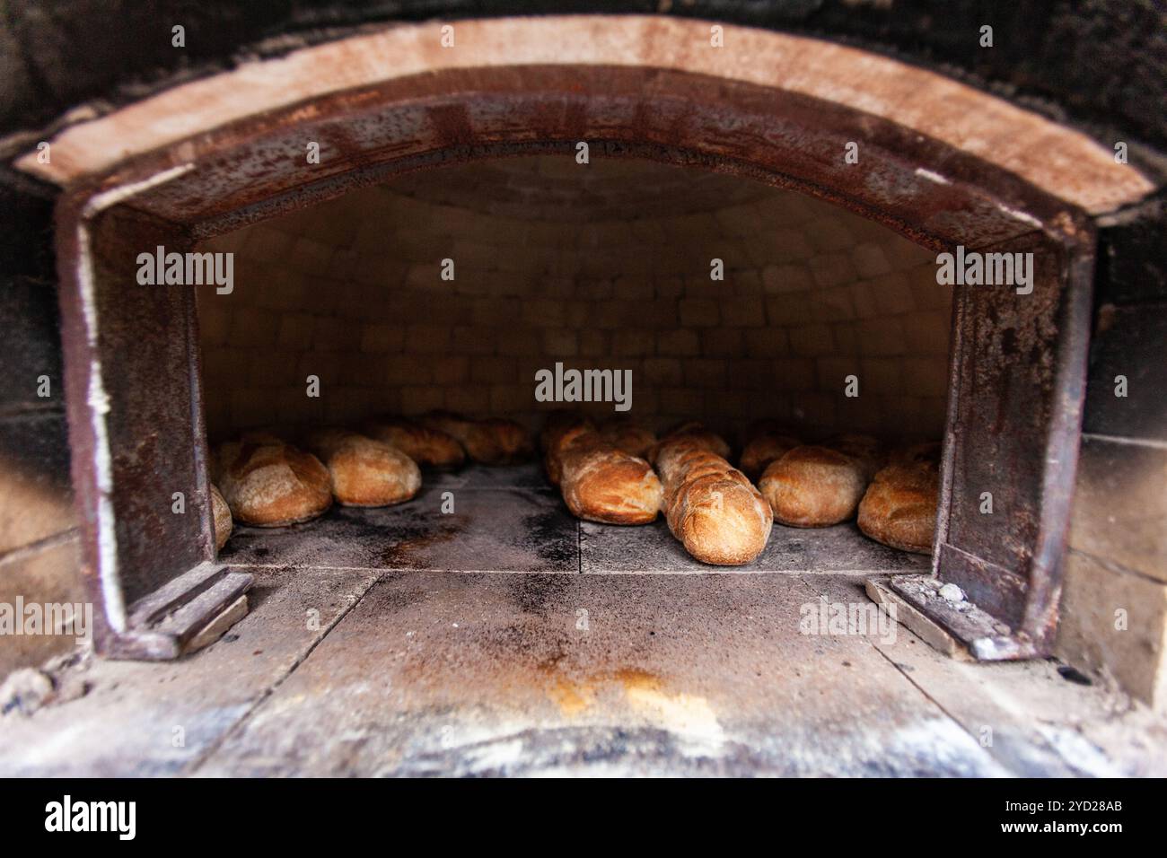 Gebogener Backofen im Freien aus Ziegeln und Lehm, voller hausgemachtem Brot Stockfoto