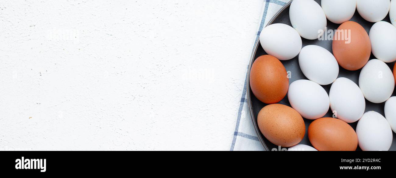 Hühnereier auf einem karierten Küchentuch auf einem Lichttisch. Das Konzept der landwirtschaftlichen Erzeugnisse und der natürlichen Ernährung. Artikel und Anzeigen zu Hause Stockfoto