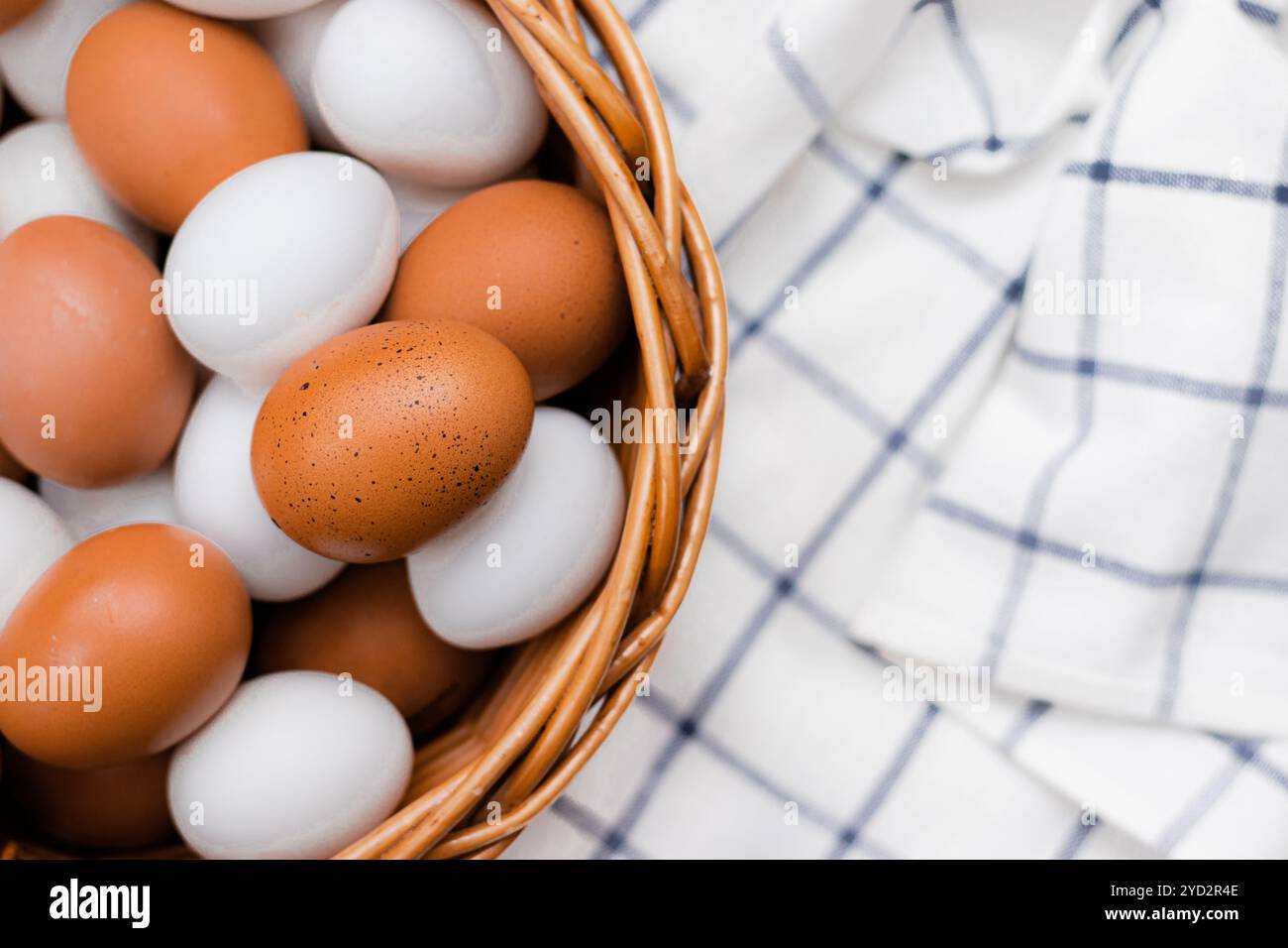 Hühnereier auf einem karierten Küchentuch auf einem Lichttisch. Das Konzept der landwirtschaftlichen Erzeugnisse und der natürlichen Ernährung. Artikel über Haushaltsprodukte Stockfoto