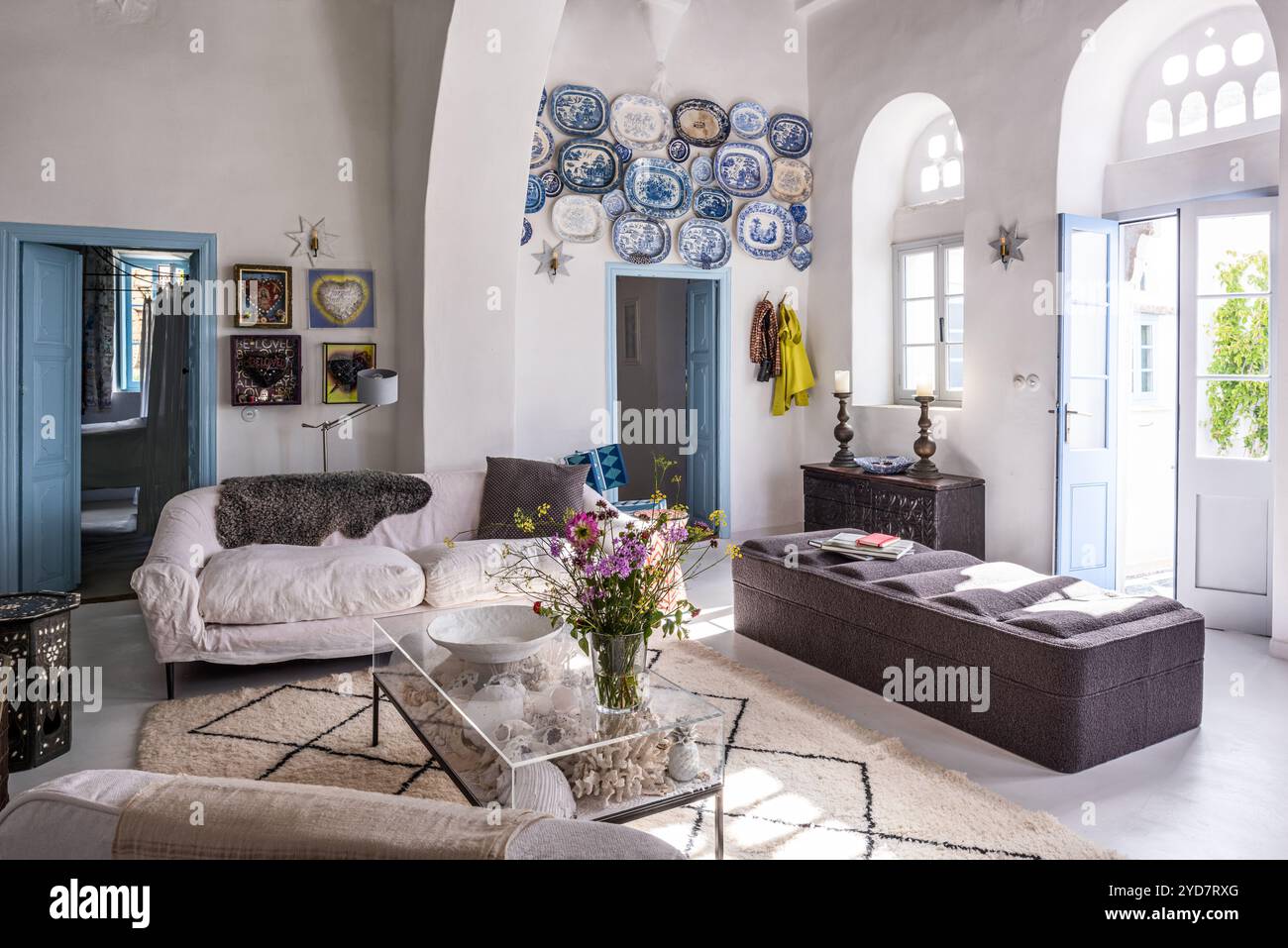 An der Wand montierte Keramikplatten und Sitzecke in einem historischen Haus auf der Insel Tinos in Griechenland Stockfoto