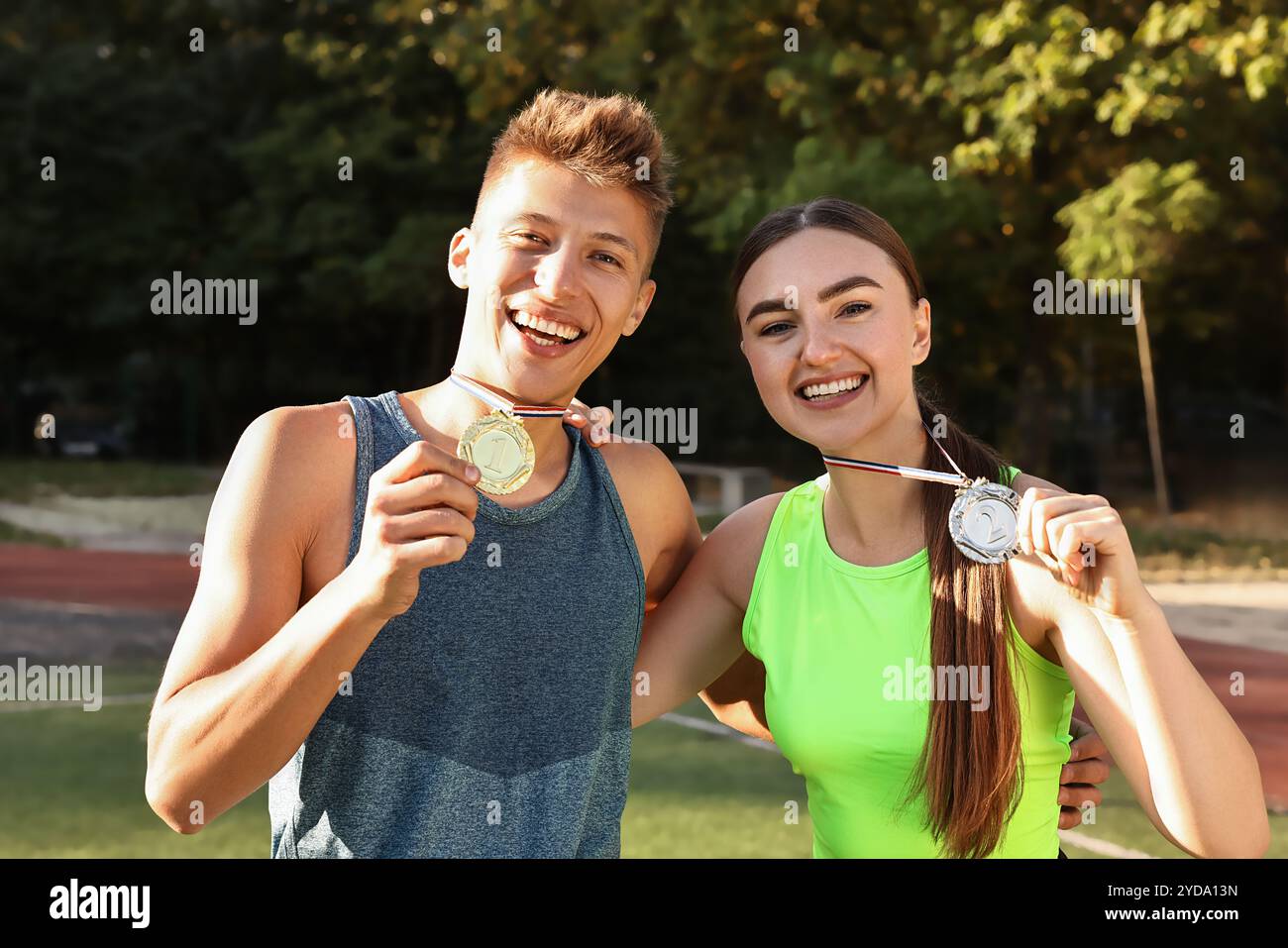 Zwei glückliche Gewinner mit Medaillen im Stadion Stockfoto