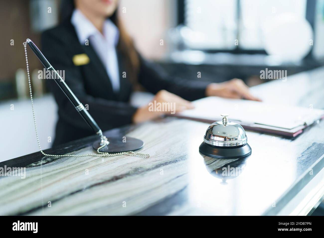 Hotelrezeptionist in Uniform am Schreibtisch in der Lobby FriendlyÂ und Empfangspersonal im Hotel Stockfoto