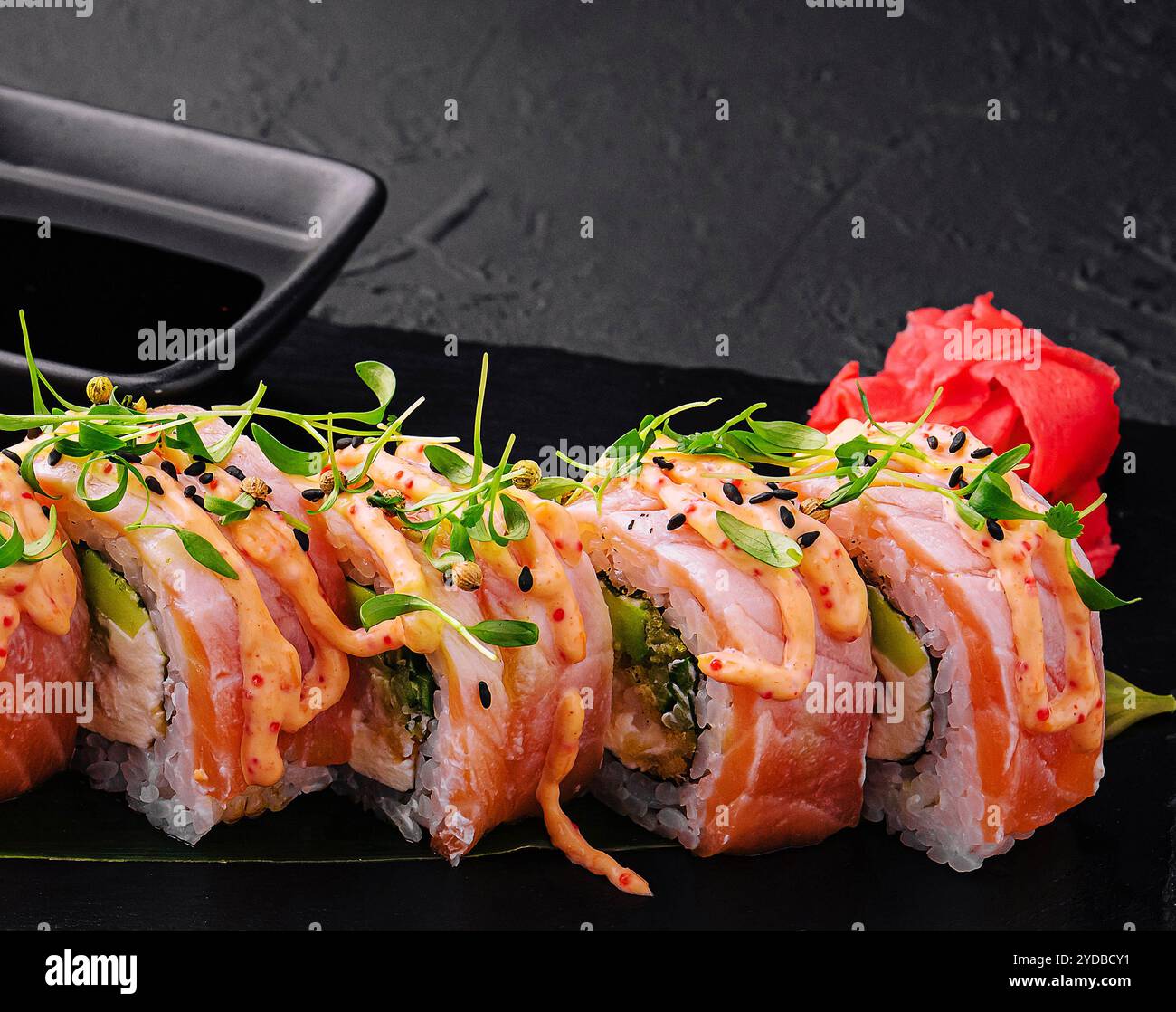 Thunfisch-Sushi-Rolle auf schwarzem Brett Stockfoto