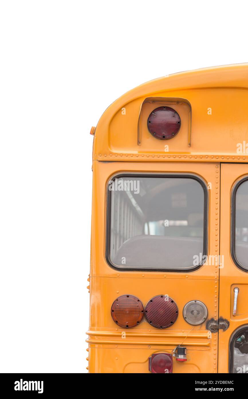 Von hinten ist ein hellgelber Schulbus vor weißem Hintergrund zu sehen Stockfoto