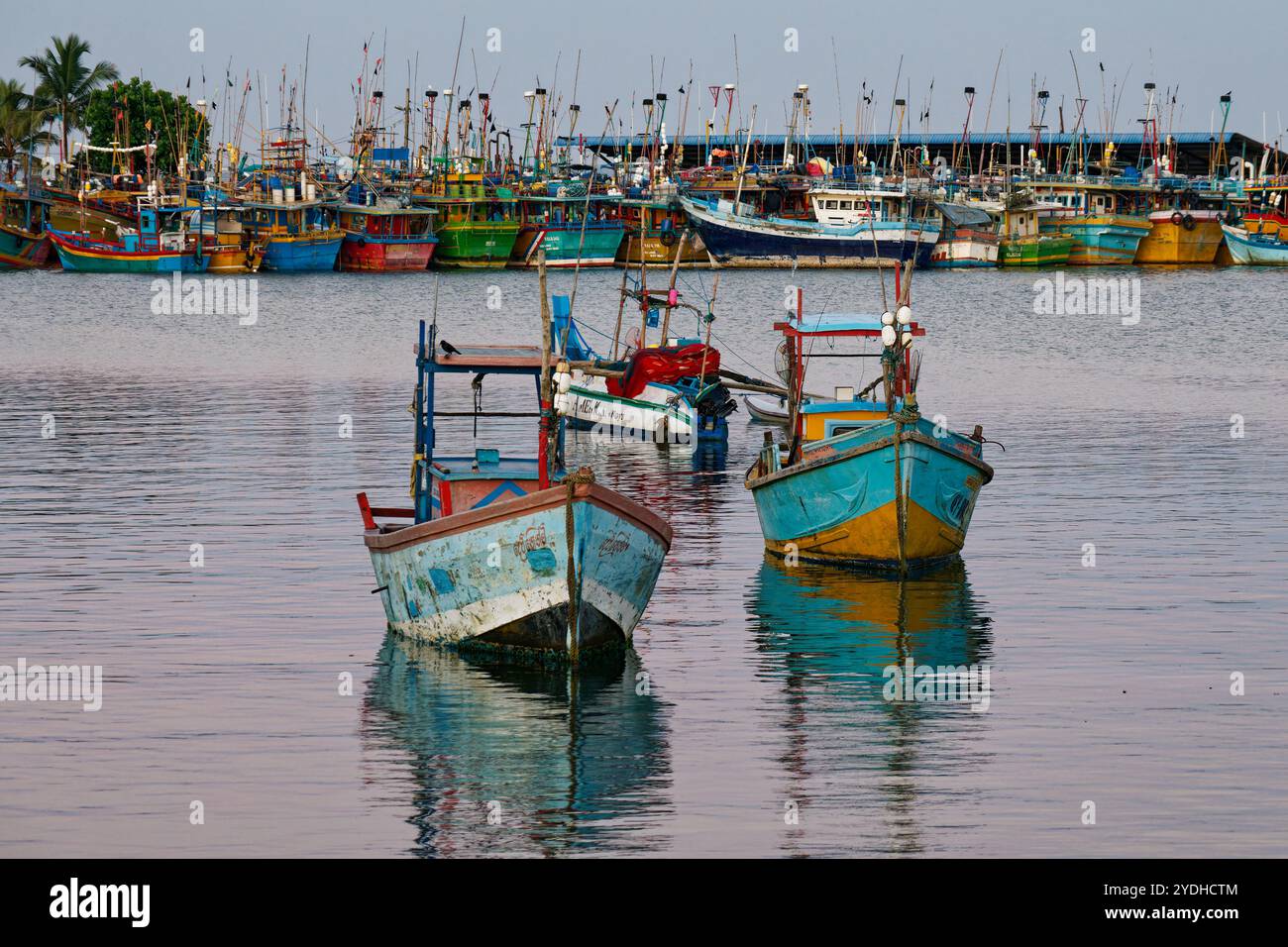 Marinehafen in der Mirissa Bay in Sri Lanka mit farbenfrohen Booten und Schiffen auf dem blauen Meer. Stockfoto