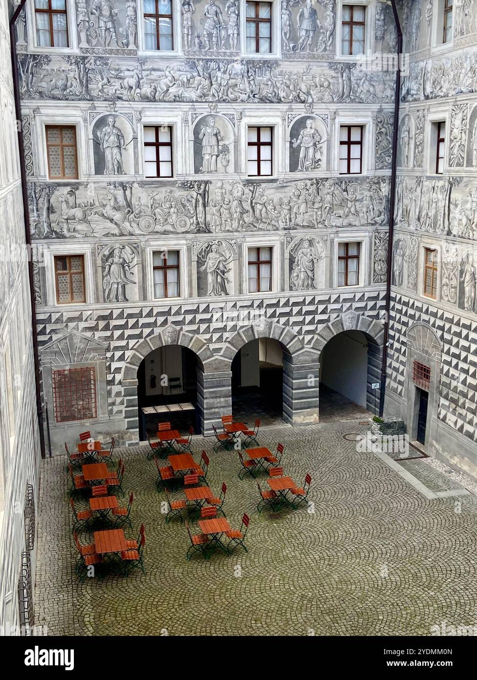 Salzburg, Österreich - 2. Oktober 2024: Atemberaubender Renaissance-Innenhof von Schloss Ambras mit Sgraffito-Wandkunst und elegantem Café im Freien Stockfoto