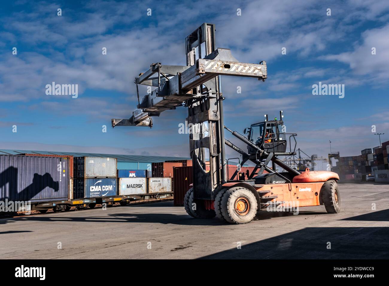 Industriehafen mit Containern und Fracht, die gelagert und auf Schiffe verladen werden Stockfoto