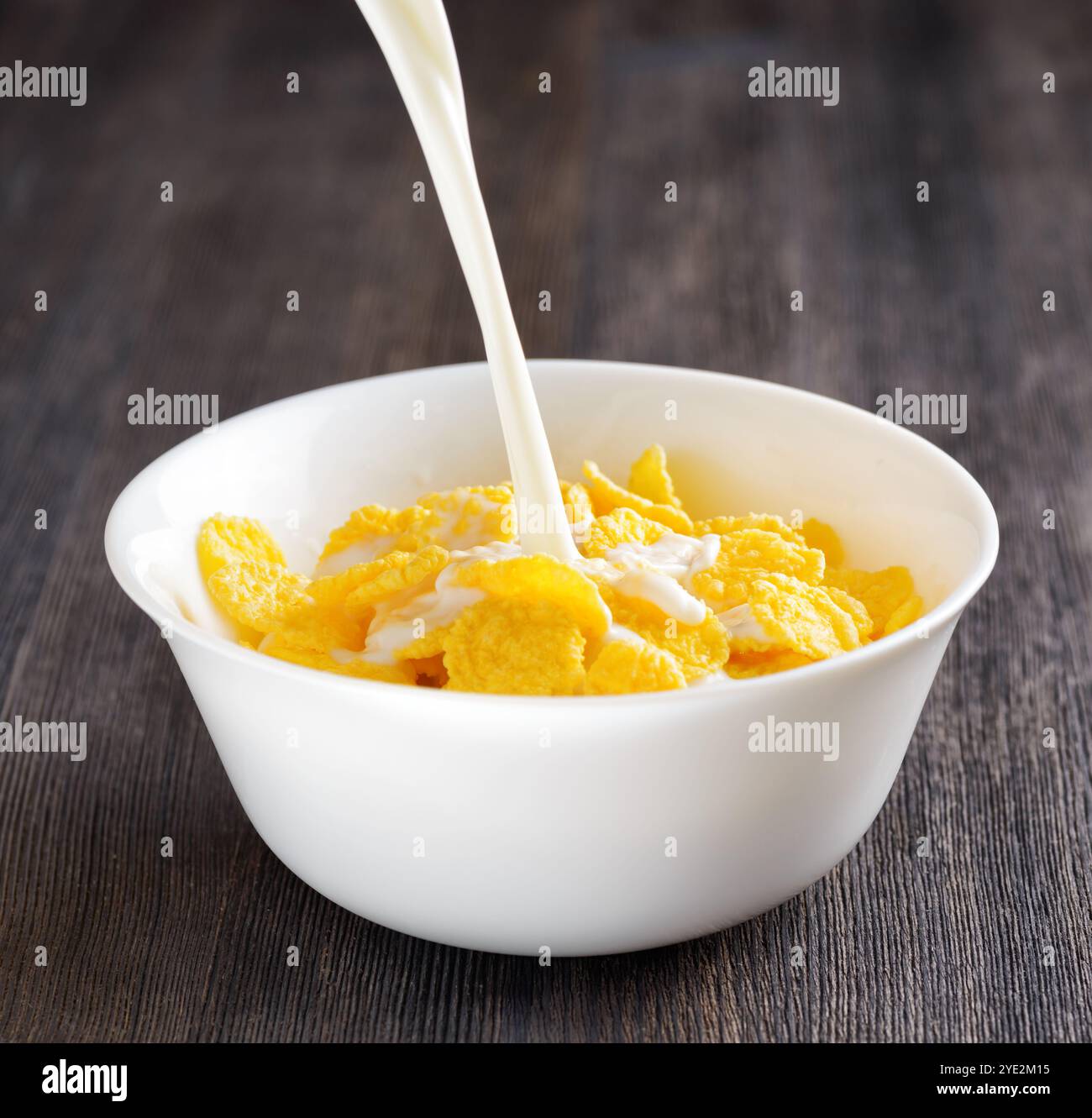 Schüssel Cornflakes auf Holztisch. Stockfoto