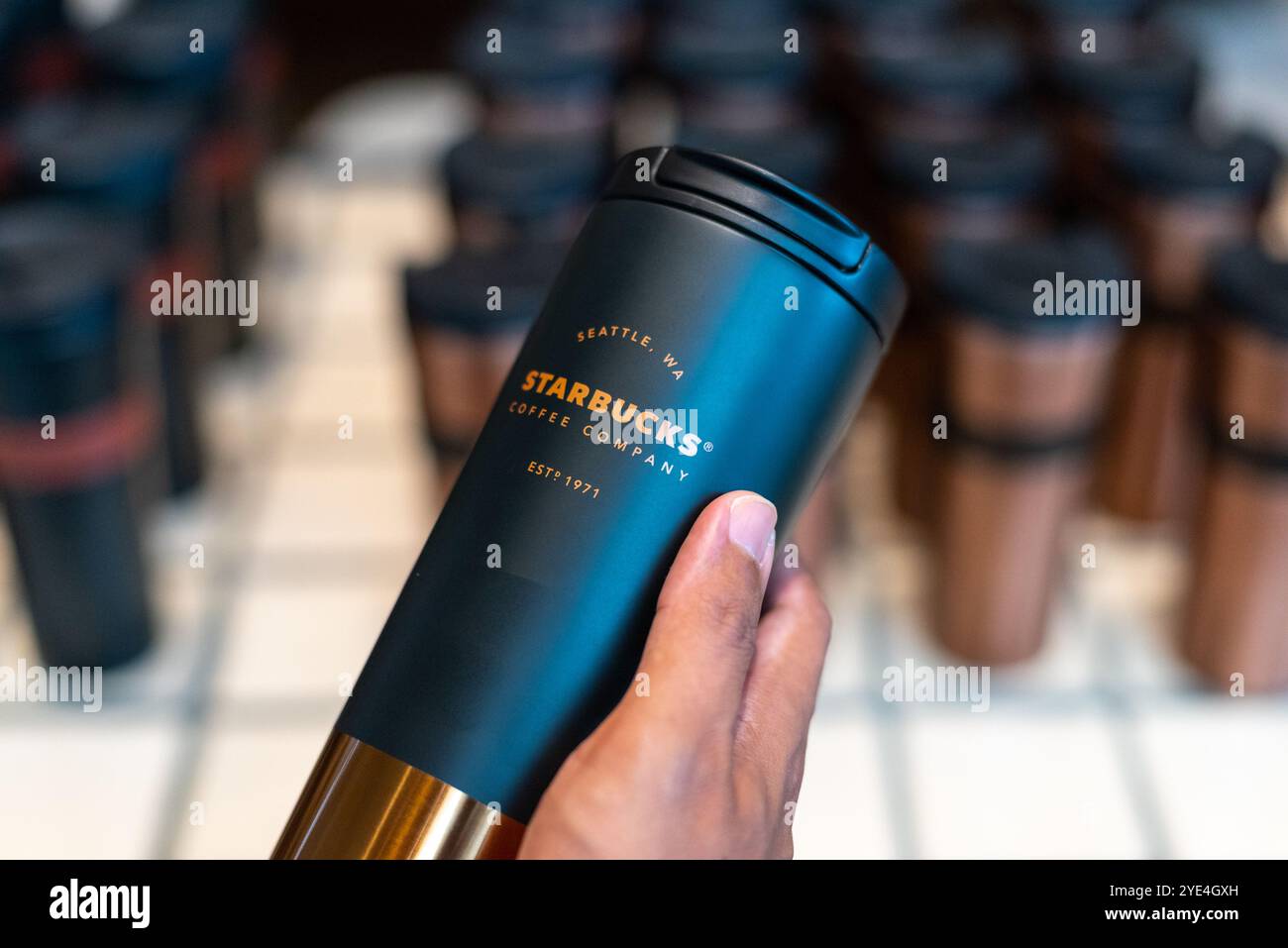 Person hält am 16. März 2024 in einem Geschäft in Bangkok, Thailand, einen Starbucks-Becher. Stockfoto