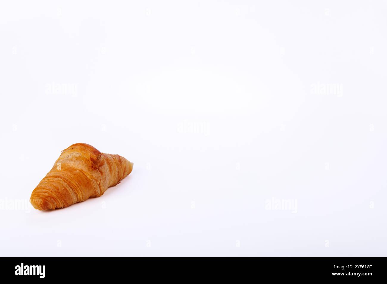 Ein verführerisches Croissant ruht vor einem endlosen weißen Hintergrund, das seine helle, schuppige Textur und warme Farbe zeigt und es zu einem Genuss für Lebensmittelfotografen macht Stockfoto