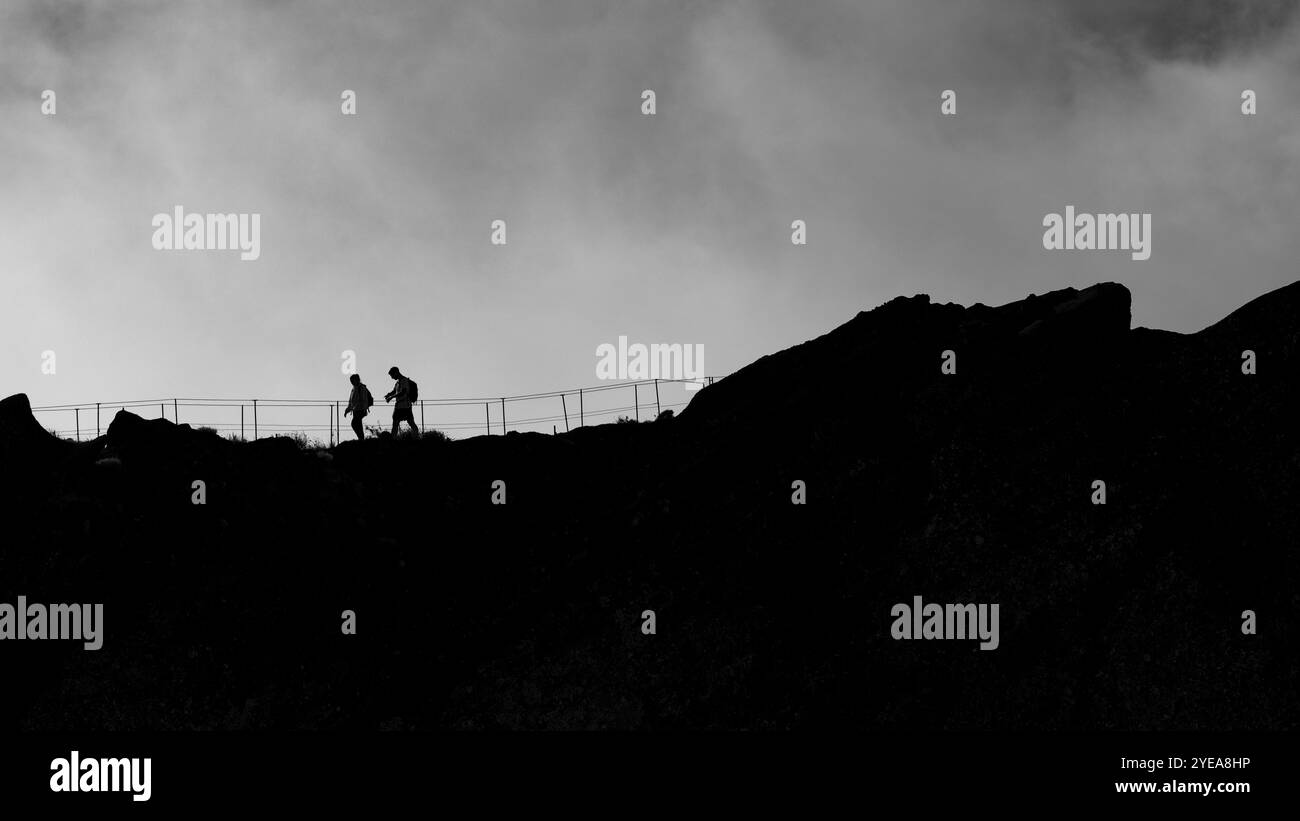 Schwarz-weiß-Bild von Wanderern mit Silhouetten auf dem Pico do Areeiro, dem dritthöchsten Gipfel der Insel Madeira, Portugal Stockfoto