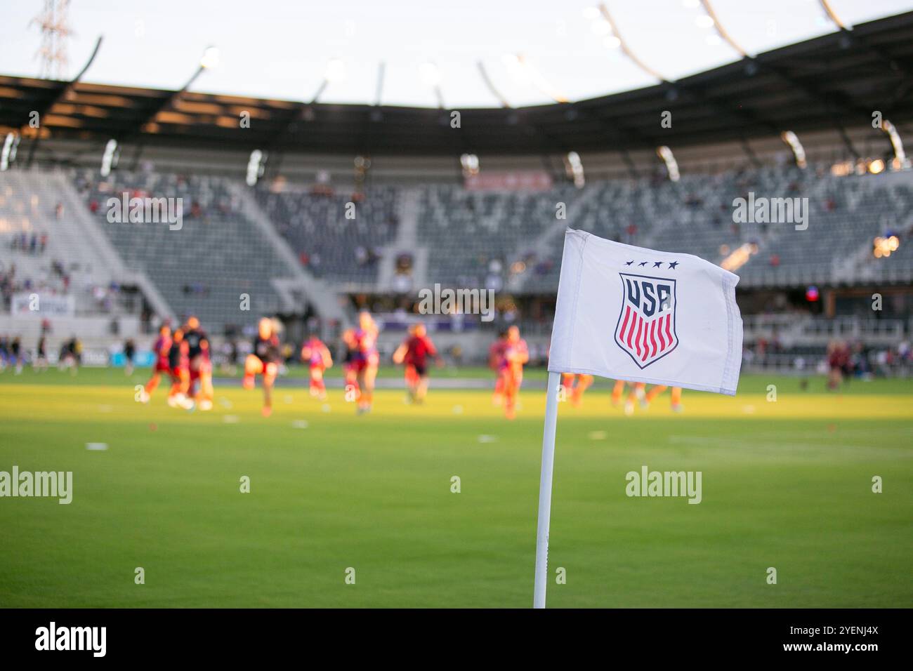 Louisville, Kentucky, USA. 30. Oktober 2024. Die US-Fußballfahne weht in einer leichten Brise, während sich das Team im Hintergrund erwärmt, bevor es im Lynn Family Stadium in Louisville, Kentucky, zu einem internationalen Freundschaftsspiel zwischen der USWNT und Argentinien kommt. Quelle: Kindell Buchanan/Alamy Live News Stockfoto