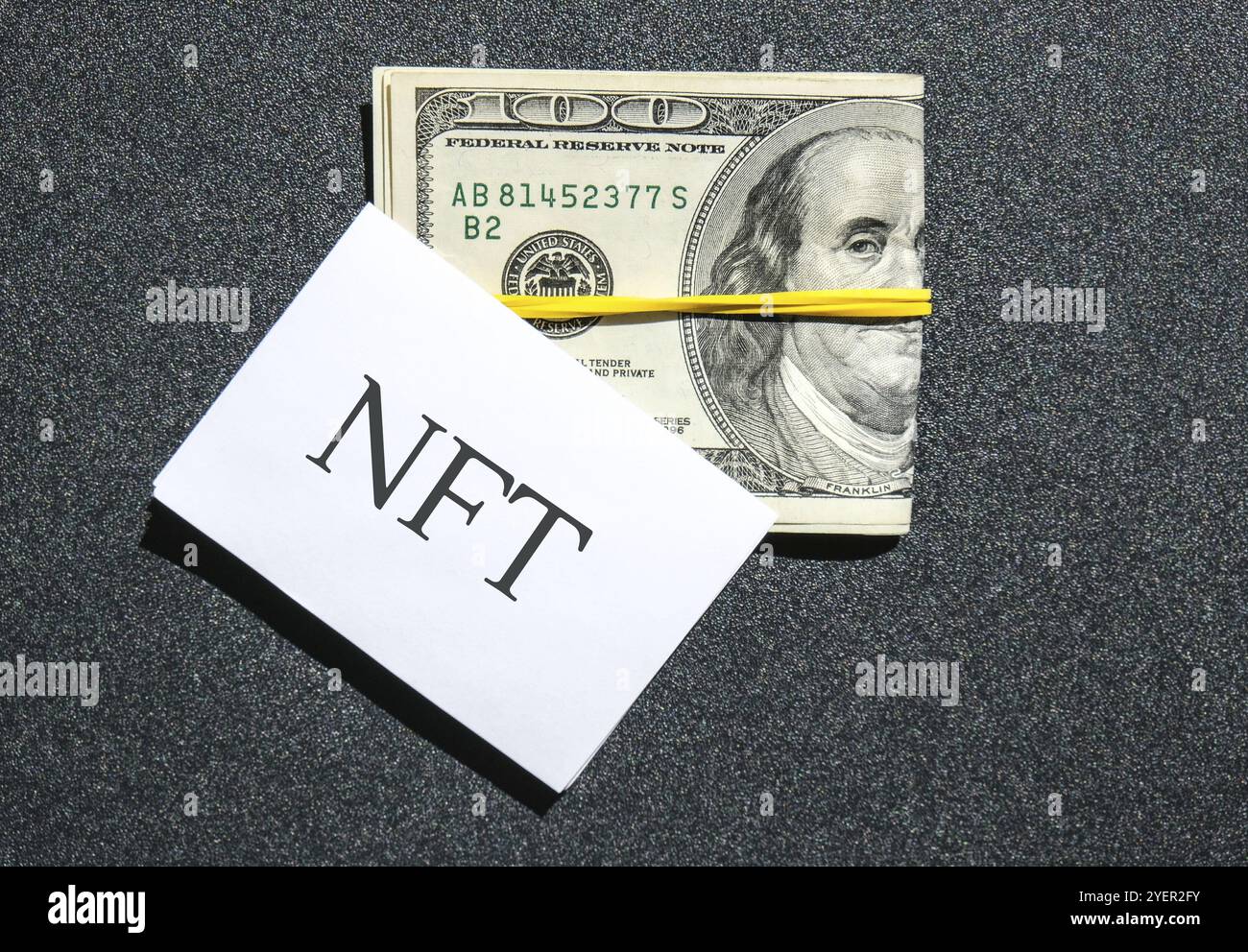 Nicht fungibler NFT-Token-Text. Concept Words NFT nicht-fungible Token auf Papierleerpapier. Hintergrund der Dollarscheine. Blockchain Asset Krypto-Kunst, digitale Kunst Stockfoto