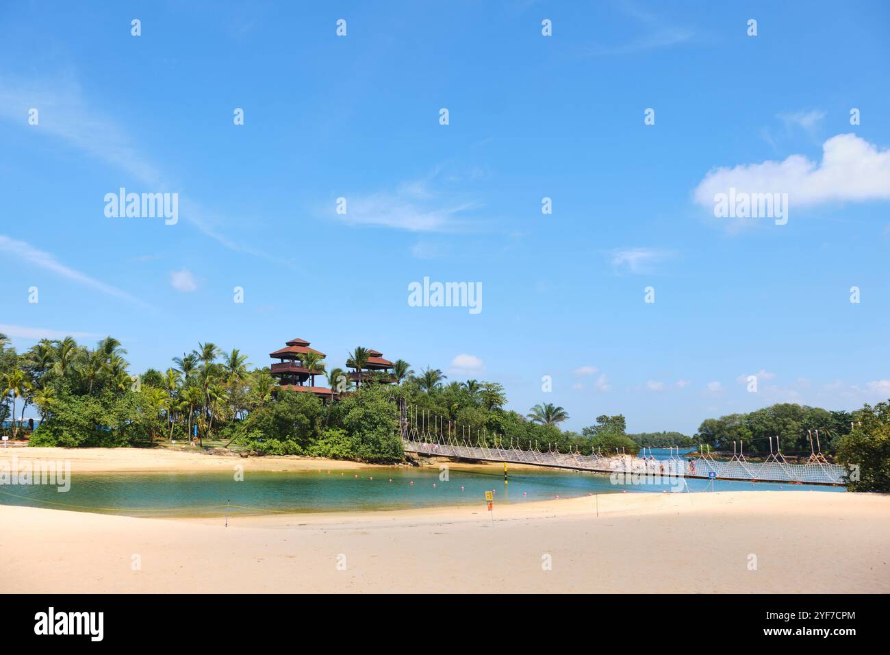 Singapur - 14. August 2024: Goldener Sand und üppige Vegetation am tropischen Palawan Beach auf der Insel Sentosa Stockfoto