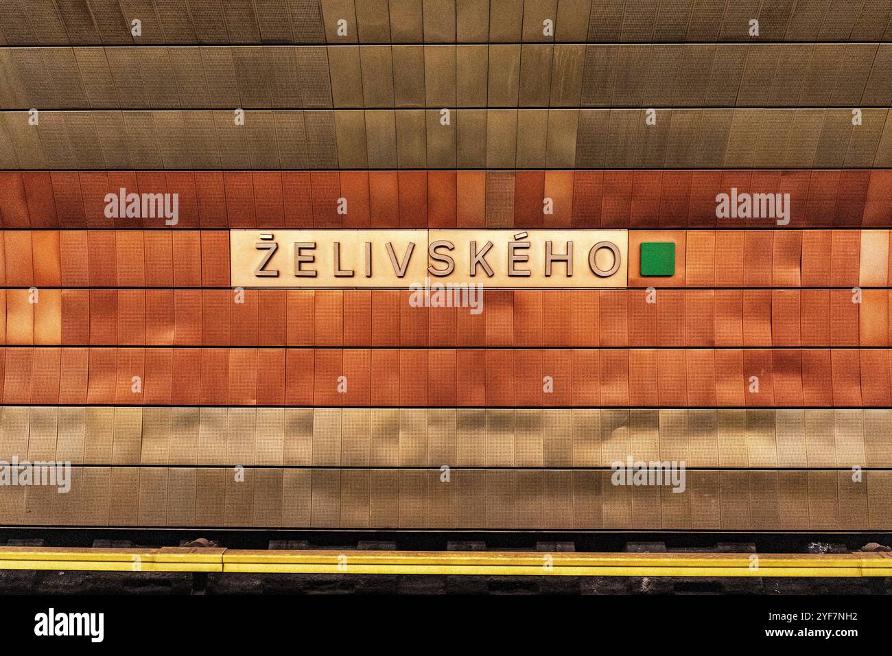 Innenraum des Bahnhofs Zelivskeho in Prag U-Bahn-Linie A, unter der Vinohradska-Straße, mit gelben und orangen Fliesen, Prag, Tschechien. Stockfoto