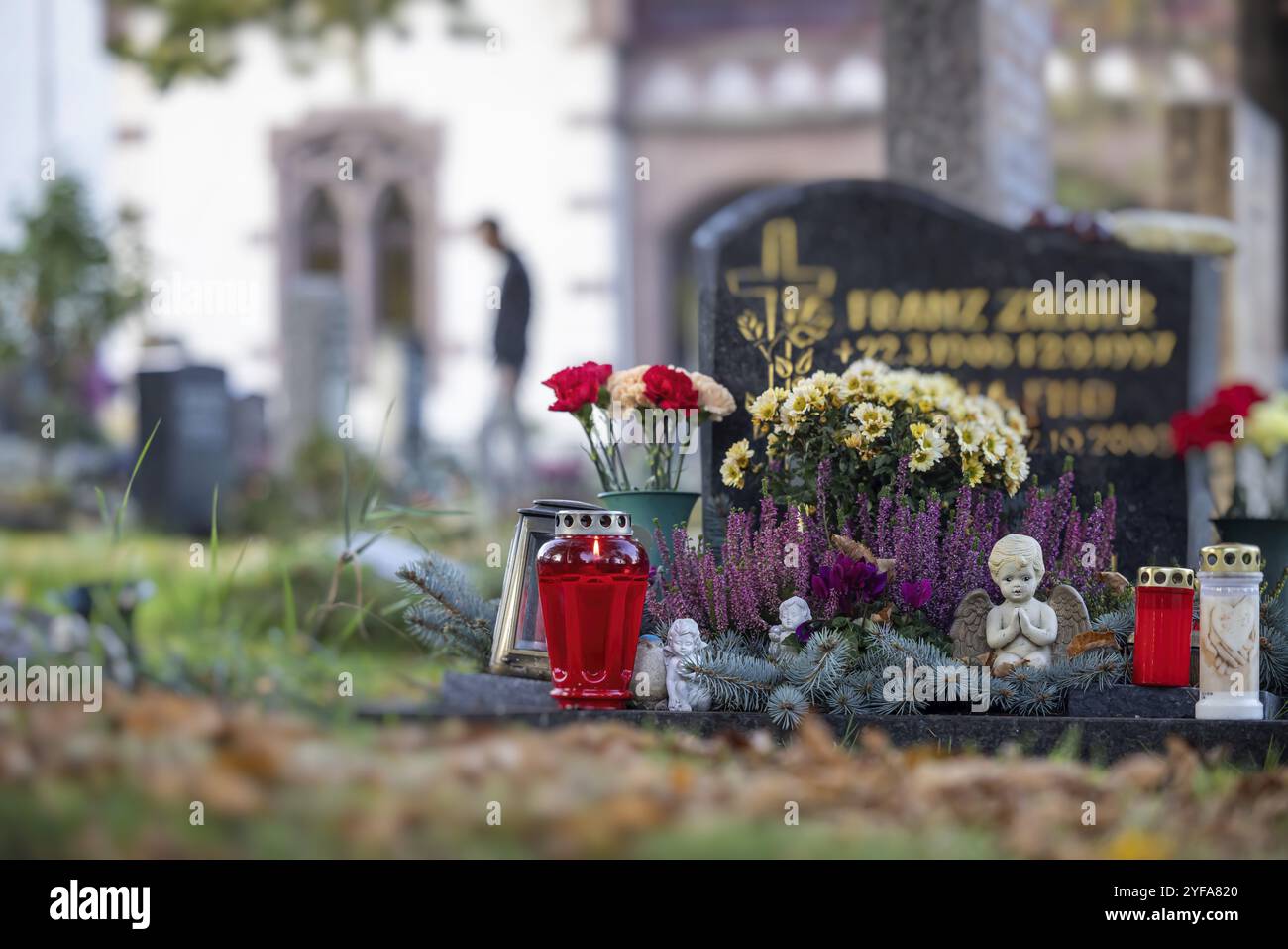 Allerheiligen auf dem Bergfriedhof in Stuttgart. Katholiken gedenken ihrer verstorbenen Verwandten. Grabdekorationen und Kerzen. Stuttgart, B Stockfoto