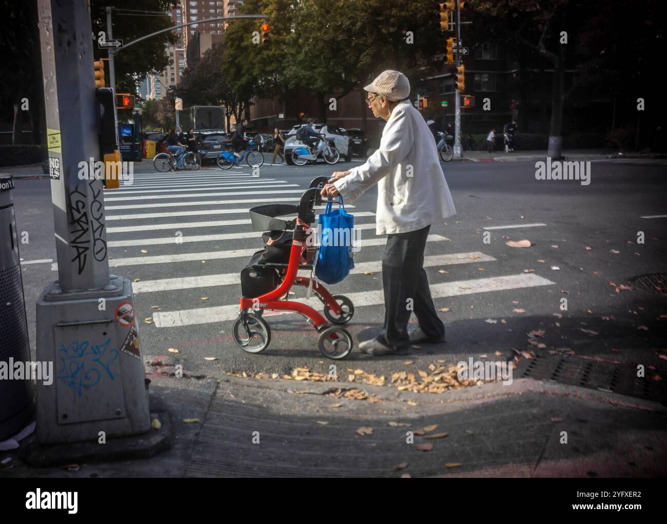 Eine ältere Frau mit ihrem Walker betritt am Donnerstag, dem 31. Oktober 2024, eine Kreuzung im Stadtteil Chelsea in New York. (© Richard B. Levine) Stockfoto