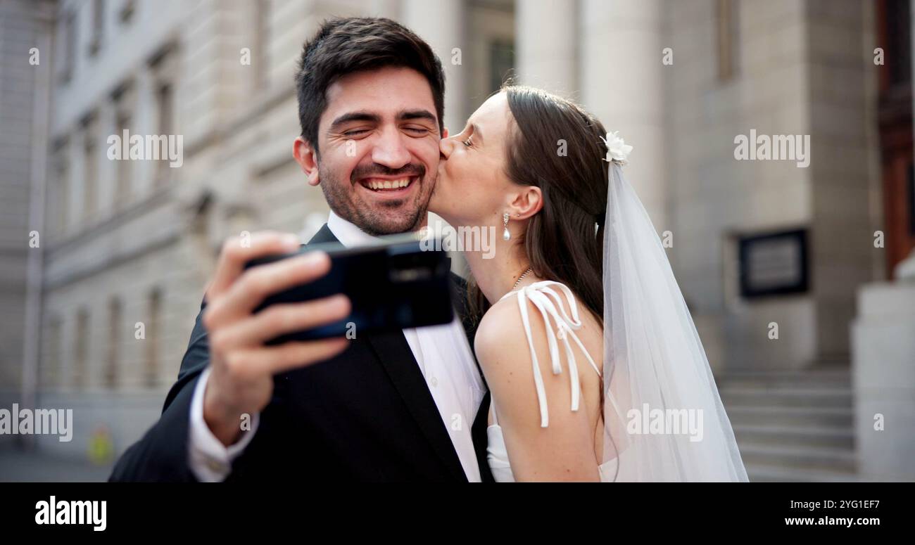 Paare, Selfie und Küsse mit Hochzeit in der Stadt, Liebe und glücklich für Engagement, Erinnerung und Post im Internet. Menschen, Mann und Frau mit Ehe, Ereignis und Stockfoto
