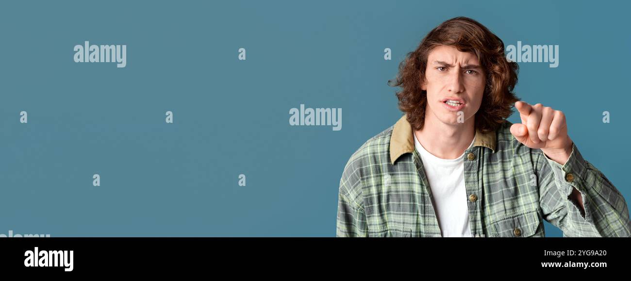 Frustrierter Teenager, der Ihnen in Anschuldigung auf Farbhintergrund zeigt Stockfoto