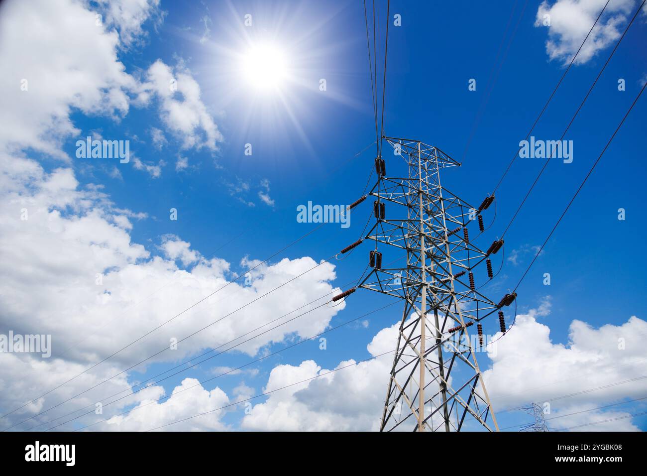 Hochspannungs-Stromübertragungsturm, Stromversorgung vom Kraftwerk in die Stadt durch Strompylon am Wolkenhimmel im Sommer. Stockfoto
