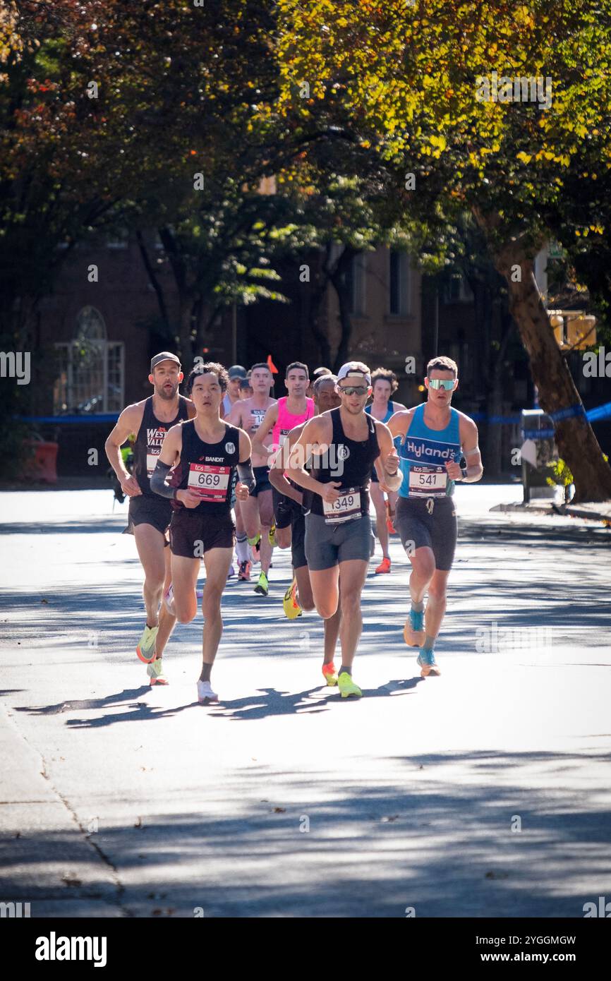 Männliche Elite-Läufer, die beim New York Marathon 2024 in der Nähe der 10-Meilen-Marke in Williamsburg, Brooklyr, im Rucksack antreten. Stockfoto