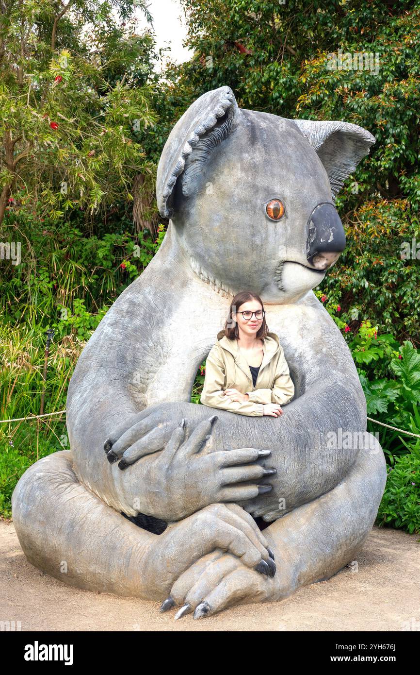 Junge Frau posiert in der Koala-Statue, Kangala Kangaroo and Wildlife Rescue, Kangaroo Island (Karta Pintingga), South Australia, Australien Stockfoto