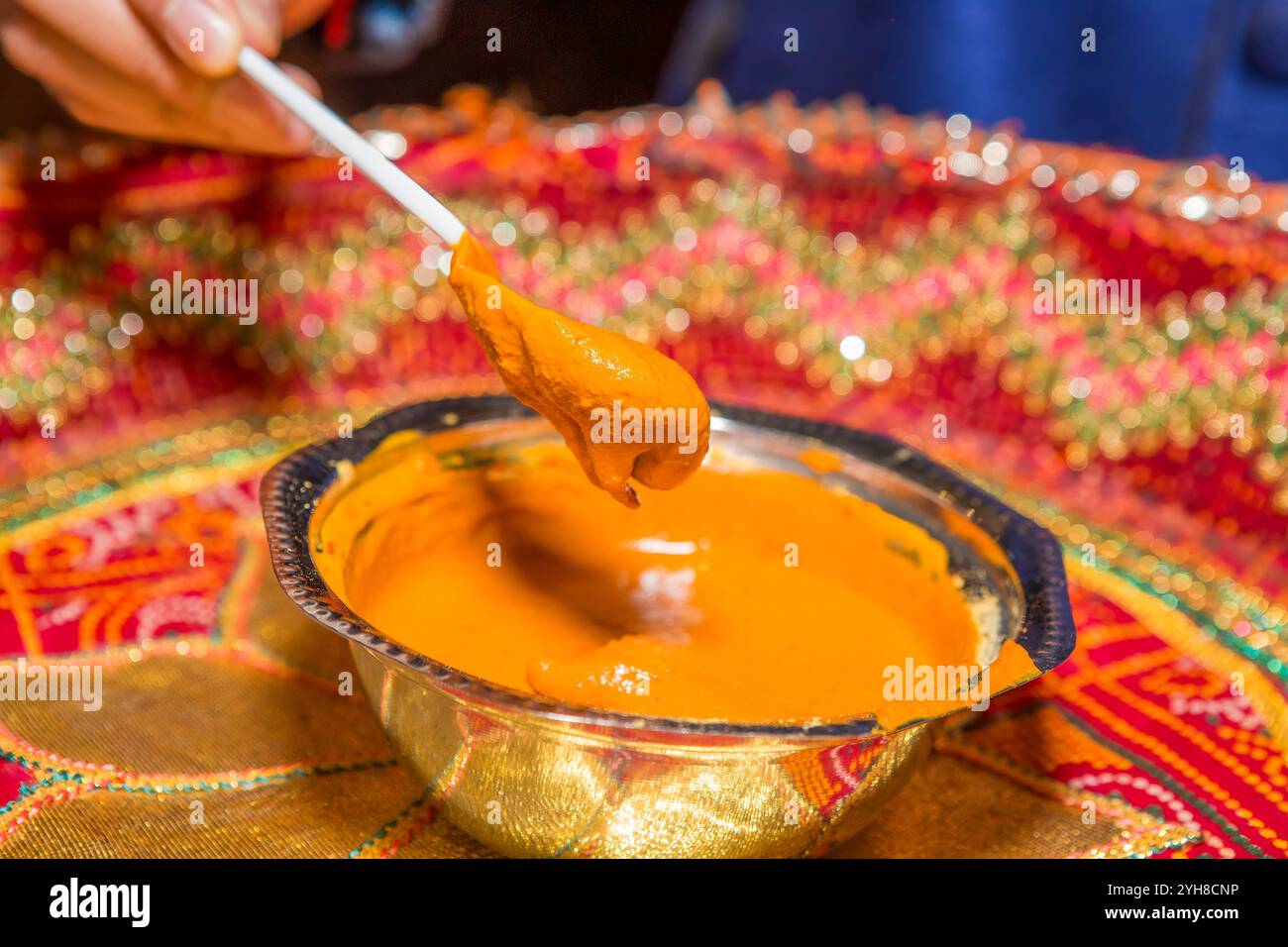 Indische Haldi-Zeremonie vor der Hochzeit mit gelber Paste in einer Schüssel – traditionelles Hautpflegeritual Stockfoto