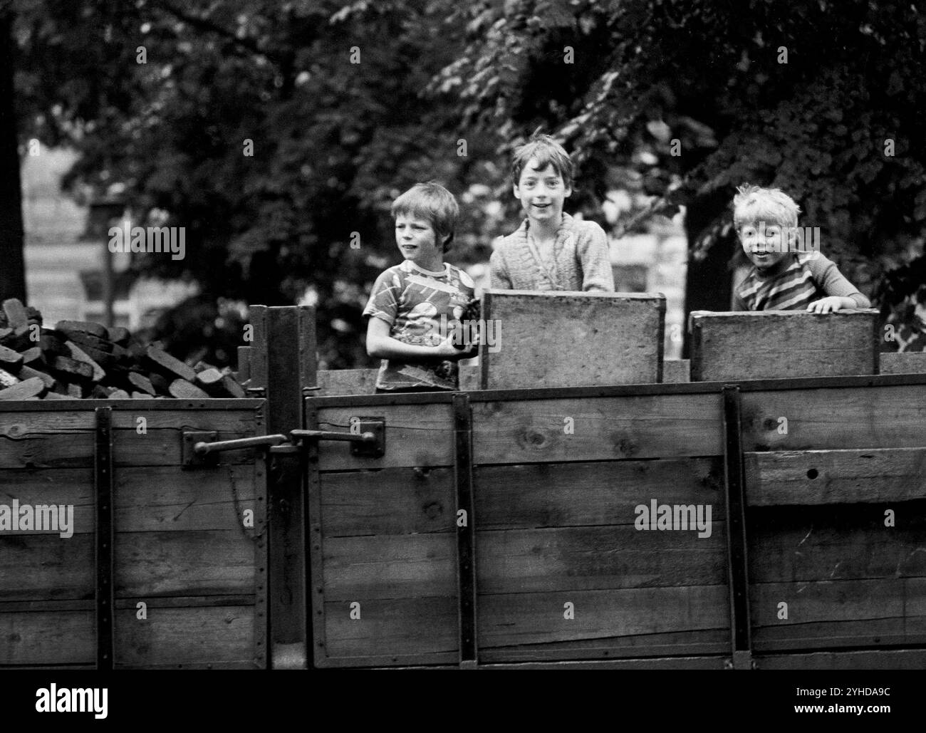 14/03/1982 DDR Ostberliner Bezirk Prenzlauer Berg. Drei Jungs spielen auf einem geparkten Kohlewagen mit Briketts. Berlin Stockfoto