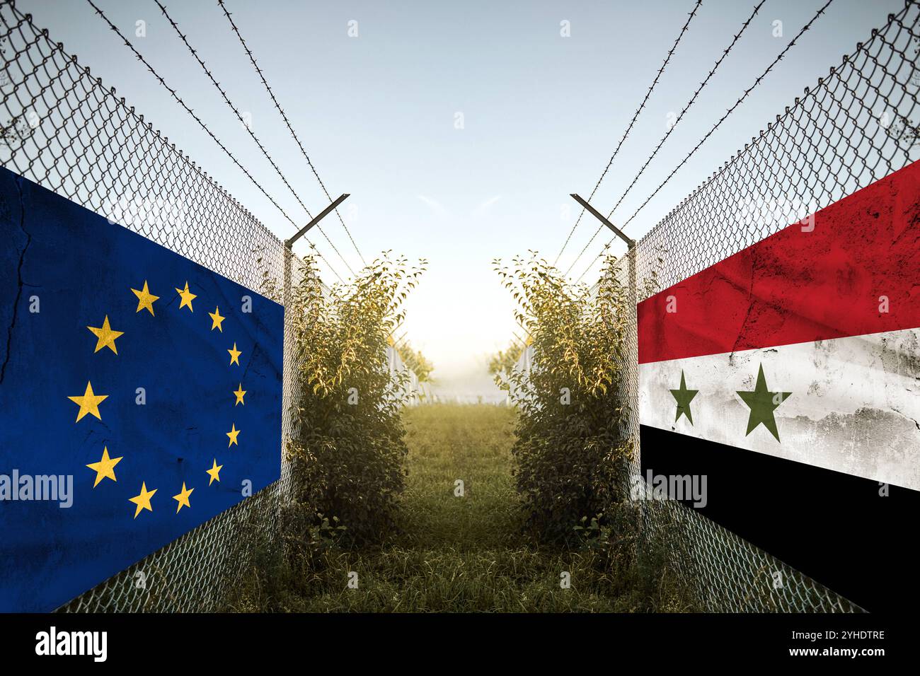 Bayern, Deutschland - 11. November 2024: Europa-Syrien-Länderflaggen an einem Grenzzaun. Symbolisches Bild für Konflikte, Streitigkeiten und Debatten, symbolisch dargestellt durch die syrische und die Europäische Union-Flagge und militärische Atmosphäre im Grenzgebiet wie im Krieg. FOTOMONTAGE *** Europa und Syrien Länder-Fahnen auf einem Zaun an einer Grenze. Symbolbild für Konflikt, Streit und Debatten, symbolisch dargestellt mit syrische und Europäische Union EU Flagge und militärische Stimmung im Grenzgebiet wie im Krieg. FOTOMONTAGE Stockfoto