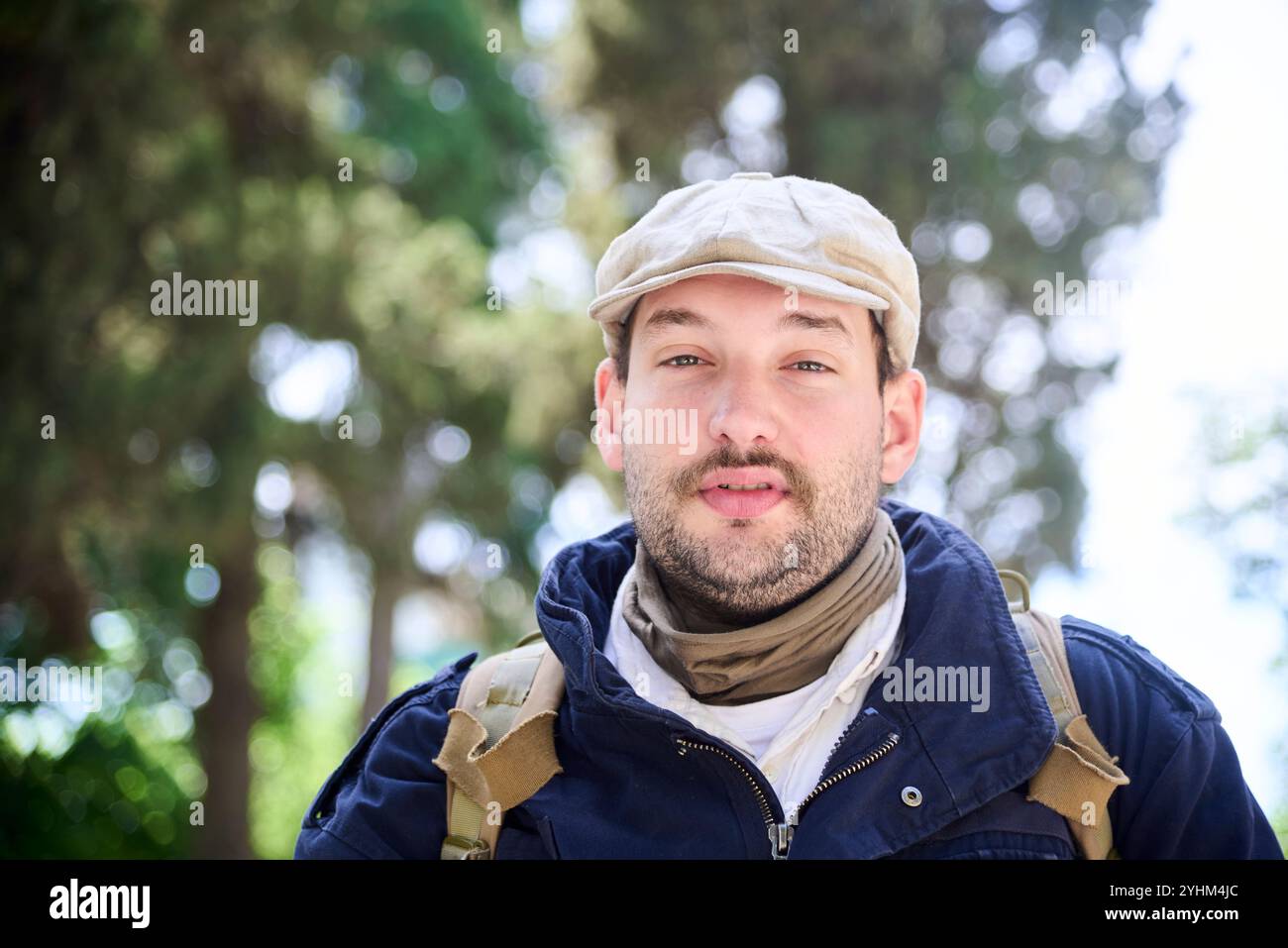 Porträt eines jungen Mannes, der draußen in die Kamera schaut. Komposition mit Kopierraum und selektivem Fokus. Stockfoto