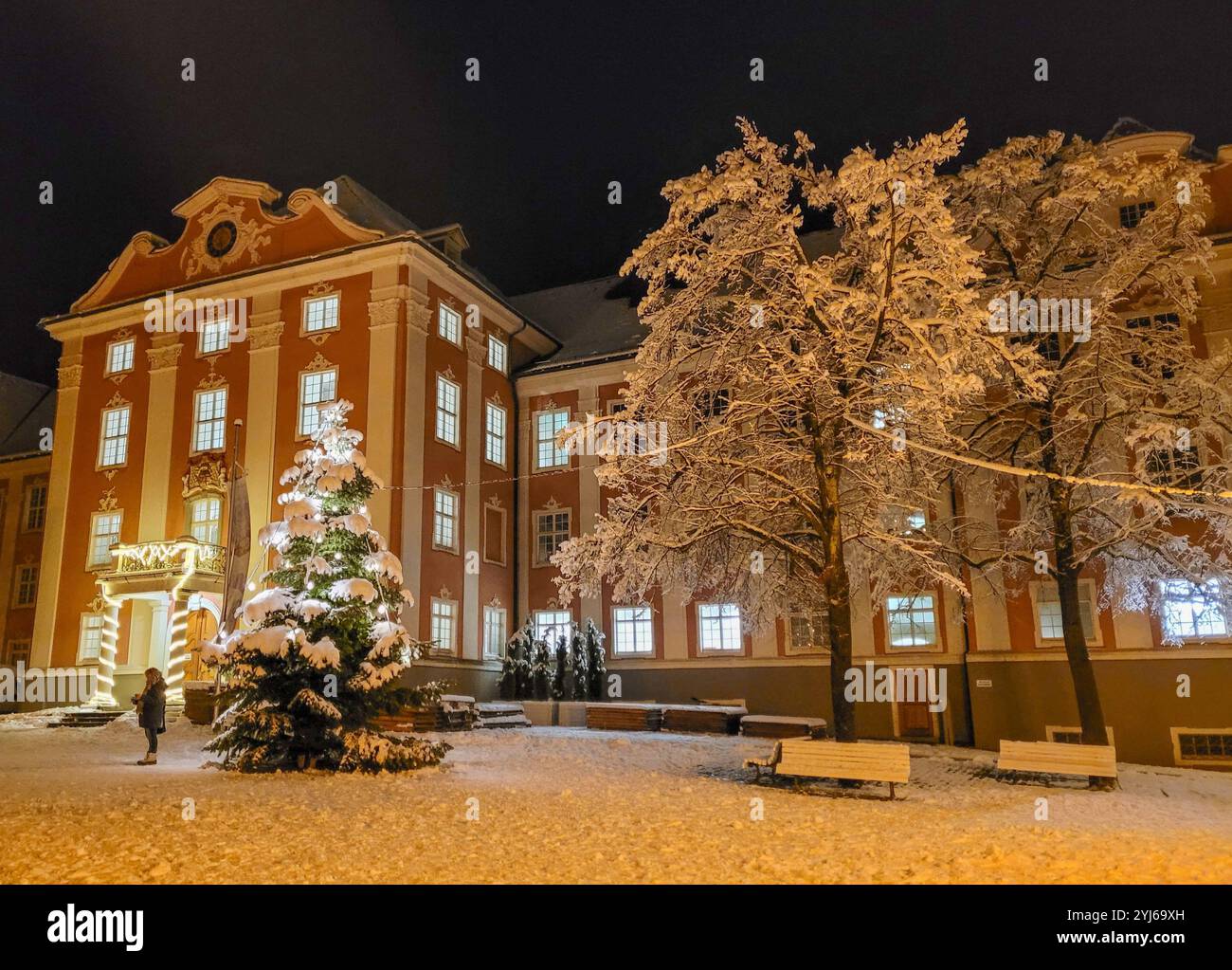Abendblick auf das neue Schloss in Meersburg, Neues Schloss im Barockstil. Im Vordergrund - ein schneebedeckter Platz, Bäume und ein Weihnachtsbaum Stockfoto