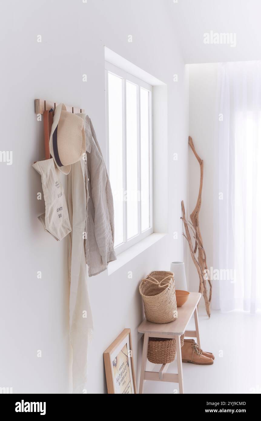 Wandhaken mit Treibholz in der Ecke und kleinen Gegenständen auf der Bank Stockfoto